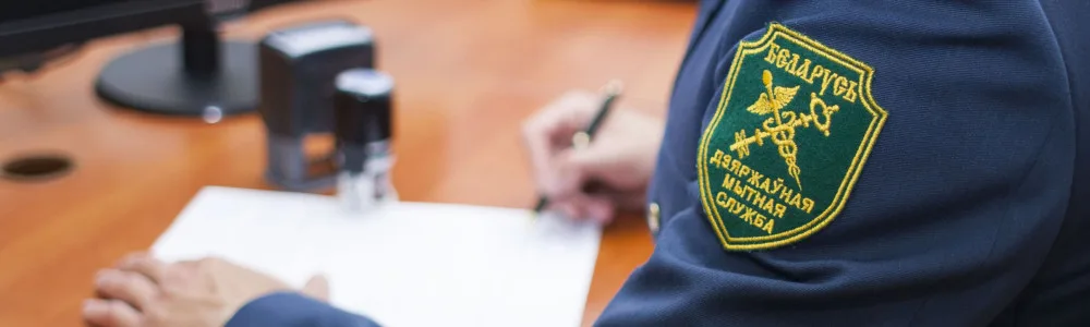 Таможенное право, рука таможенника подписывает документ