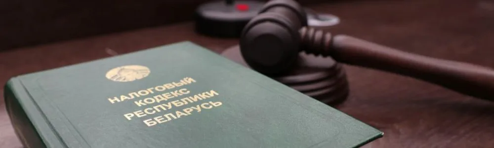 Налоговое право, налоговый кодекс Республики Беларусь на столе с молотком судьи